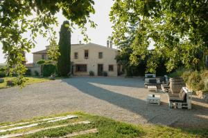 a house with a large yard with benches in front of it at Masia Olivera in Sant Pau dʼOrdal +53 photos
