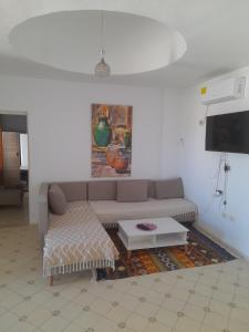a living room with a couch and a tv at Taguermess Tag 5 in Taguermess