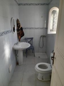 a bathroom with a toilet and a sink and a shower at Taguermess Tag 5 in Taguermess +1 photo