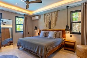 a bedroom with a bed and a ceiling fan at Elements Rituals Beachfront Bahia Soliman Tulum in Tulum +152 photos