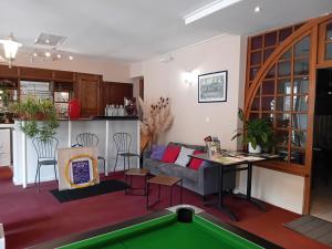 a living room with a pool table at Hôtel La Gravenne in Thueyts