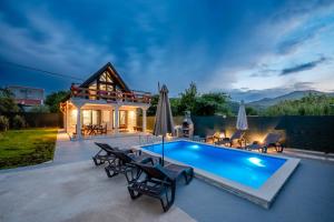 a patio with a swimming pool and a house at Villa Ksenija with Private Pool- Peace & Privacy in Bar