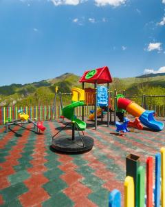 a playground with many different types of playground equipment at Grotto Resort & Restaurant in Quba