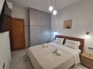 a bedroom with a bed with two towels on it at Manolas Sunset View in Glinádhon