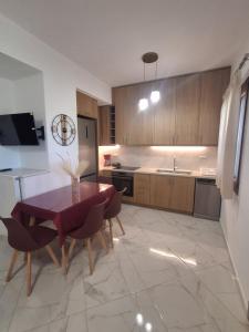 a kitchen with a table and chairs and a sink at Manolas Sunset View in Glinádhon