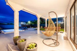 a hammock on the patio of a house at Villa Ksenija with Private Pool- Peace & Privacy in Bar