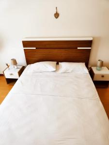 a large white bed in a bedroom with two night stands at Flor da Providência in Viseu +20 photos