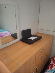 a bedroom with a desk with a laptop on it at Chambre d'hôte Mles bêtes in Avensan