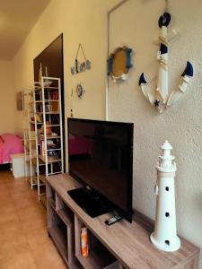 a living room with a flat screen tv and a lighthouse at brezza marina in Siderno Marina