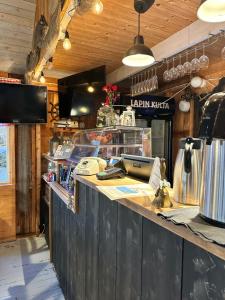 a kitchen with a counter in a restaurant at Sandvik Gästhamn & Camping in Kökar