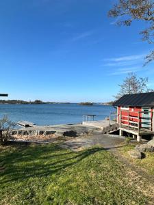 a house on the shore of a body of water at Sandvik Gästhamn & Camping in Kökar