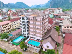 an overhead view of a city with buildings and a pool at Vangvieng Sisavang Mountain View Hotel in Vang Vieng
