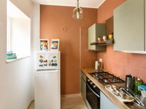 a kitchen with a white refrigerator and a stove at Interi Appartamenti in Centro - Holiday & Wi-Fi Ultra in Campobasso +35 photos