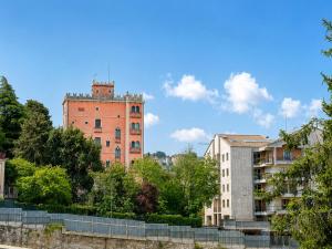 an old brick building in a city with trees at Interi Appartamenti in Centro - Holiday & Wi-Fi Ultra in Campobasso