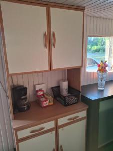 a kitchen with white cabinets and a counter top at Chambre d'hôte Mles bêtes in Avensan