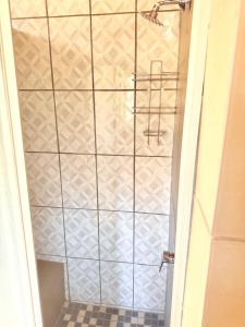 a shower with a glass door in a bathroom at Mabalingwe Mistykie Lodge in Warmbaths +34 photos