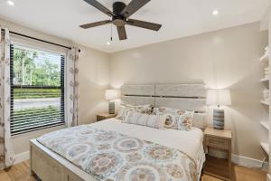 a bedroom with a bed and a ceiling fan at Park Shore Resort by Mike Z Rentals in Naples