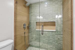a shower with a glass door in a bathroom at Park Shore Resort by Mike Z Rentals in Naples