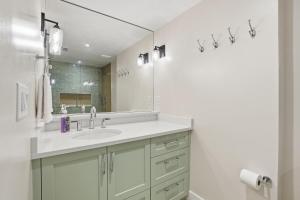a bathroom with a sink and a mirror at Park Shore Resort by Mike Z Rentals in Naples