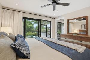 a bedroom with a large bed and a mirror at Park Shore Resort by Mike Z Rentals in Naples