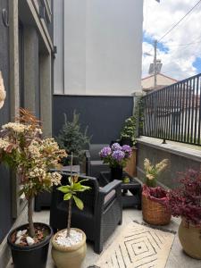 a patio with potted plants on a balcony at Liams Cozy Villa in Korçë