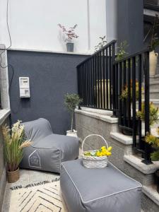 a balcony with a basket of fruit on a ottoman at Liams Cozy Villa in Korçë