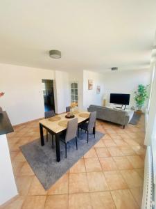 a living room with a table and chairs and a couch at Familly Jean Bart-Centre-ville in Dunkerque