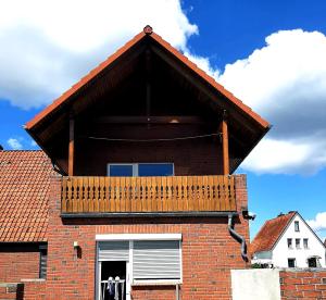 a balcony on the side of a brick building at Heide Nest Soltau in Soltau