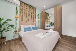 a bedroom with a large bed with towels on it at Stylish & Sleek Flat near the Beach by HostWise in Armação de Pêra