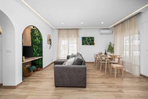 a living room with a couch and a table at Stylish & Sleek Flat near the Beach by HostWise in Armação de Pêra +35 photos