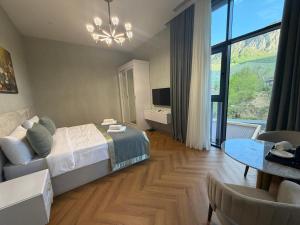 a bedroom with a bed and a living room at Grotto Resort & Restaurant in Quba