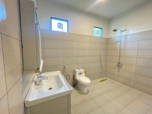 a bathroom with a sink and a toilet at The Northleaf Cottage in Skardu +4 photos