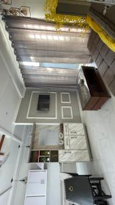 an overhead view of a kitchen with white cabinets at The Northleaf Cottage in Skardu