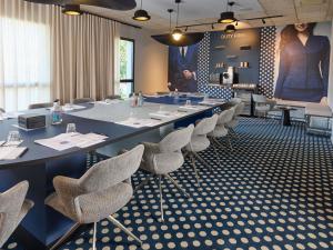 a meeting room with a long table and chairs at Novotel Valence Sud in Valence +130 photos