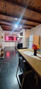 a kitchen with a table with a vase of flowers on it at Paseo Dean Funes Dúplex in San Rafael