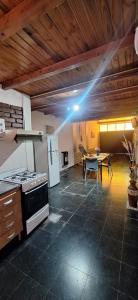 a kitchen with a stove and a table in it at Paseo Dean Funes Dúplex in San Rafael +15 photos