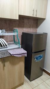 a kitchen with a black refrigerator next to a counter at Serenity Breeze in Ongata Rongai 