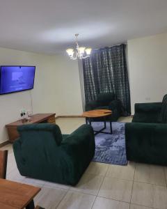 a living room with a couch and a table at Serenity Breeze in Ongata Rongai 