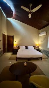 a bedroom with a bed and a ceiling fan at Sukoon Resorts Skardu in Skardu