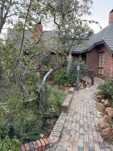 a brick walkway in front of a house at Mabalingwe Mistykie Lodge in Warmbaths