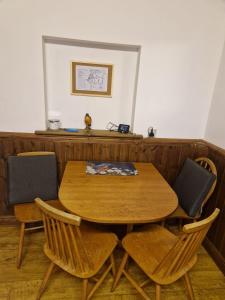 a wooden table and chairs in a room at Kingfisher Cottage Wales in Llanidloes +19 photos