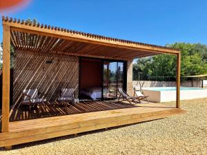 a gazebo with two chairs and a bed at Luz Retreat in Luz de Tavira