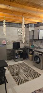 a kitchen with a stove and appliances in a room at Nada house in Dahab