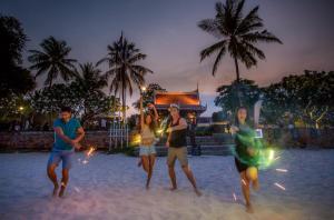 a group of people playing on the beach at night at Centara Grand Beach Resort Hua Hin in Hua Hin +233 photos