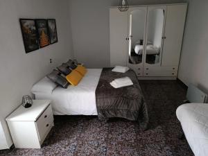 a bedroom with a large bed and a mirror at Casa el moral 2 in Castillejo de Martín Viejo +4 photos