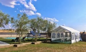 a white tent in a yard with a pool at Casa el moral 2 in Castillejo de Martín Viejo