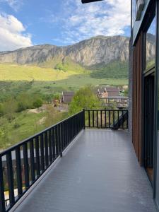 a balcony with a view of a mountain at Grotto Resort & Restaurant in Quba