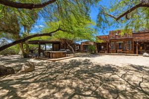 an exterior view of a house with a tree at The Bubbling Wells Oasis, 3 Homes on 107 Acres in Desert Hot Springs