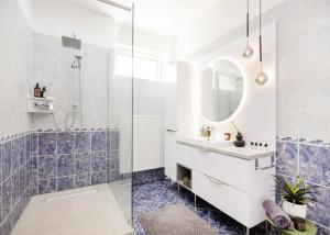 a bathroom with a sink and a mirror at Riverside Apartman**** Miskolc in Miskolc +71 photos