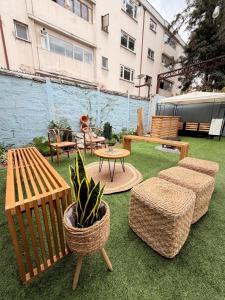 a patio with benches and a table and a potted plant at Hostal Andino in Santiago